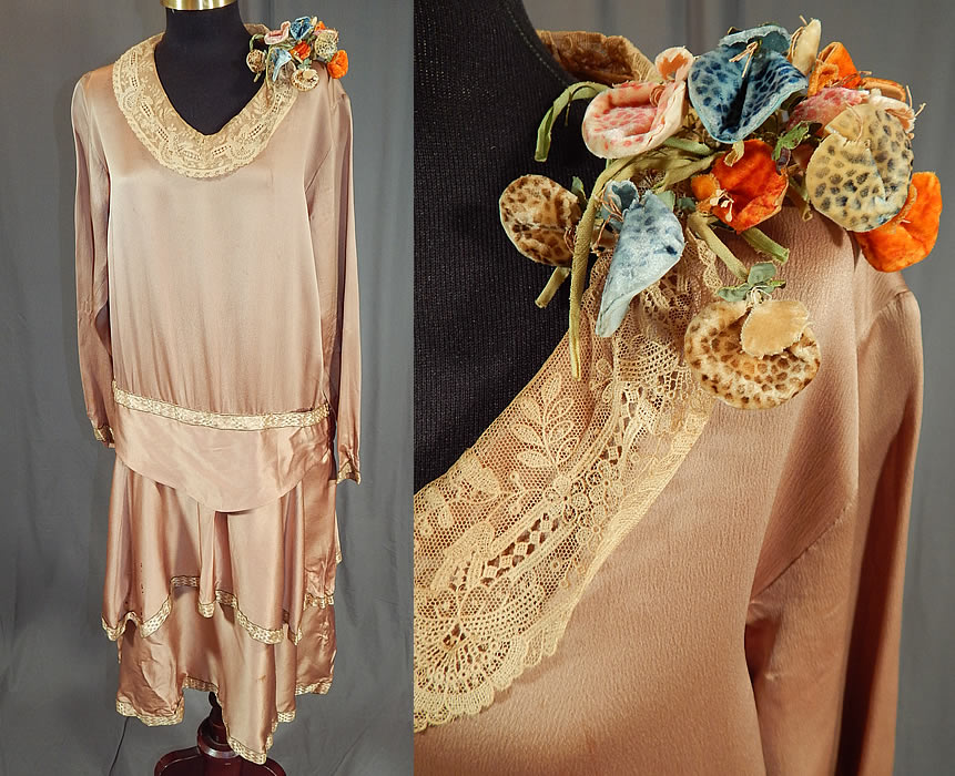 Vintage Ecru Beige Silk Lace Collar Spotted Velvet Flower Trim Drop Waist Dress
This vintage ecru beige silk lace collar spotted velvet flower trim drop waist dress dates from the 1920s. It is made of an ecru beige color silk fabric, with a cream colored lace collar, gold lamé trim edging around the waist, skirt, sleeve cuffs and an unusual colorful spotted velvet flower bouquet trim on the shoulder. 