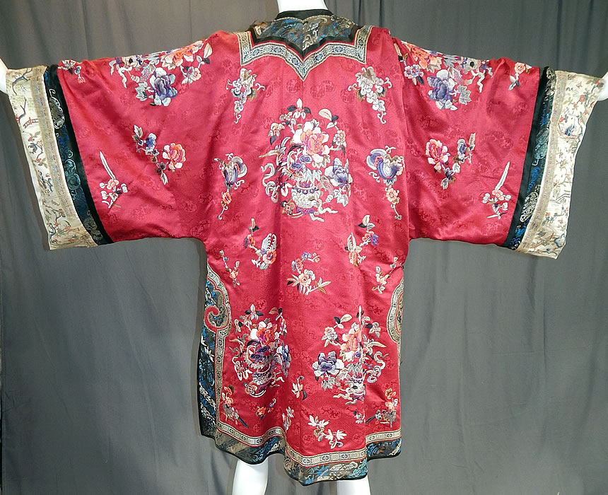 Antique Chinese Red Silk Embroidered Forbidden Stitch Sleeve Band Cuff Qipao Robe
This magnificent Manchu womens qipao one piece dress style robe is loose fitting, a long mid length, with a rounded neckline, wide full long sleeves, a front side opening, black silk loops, round brass button toggle closures which are loose and is fully lined in a blue silk.