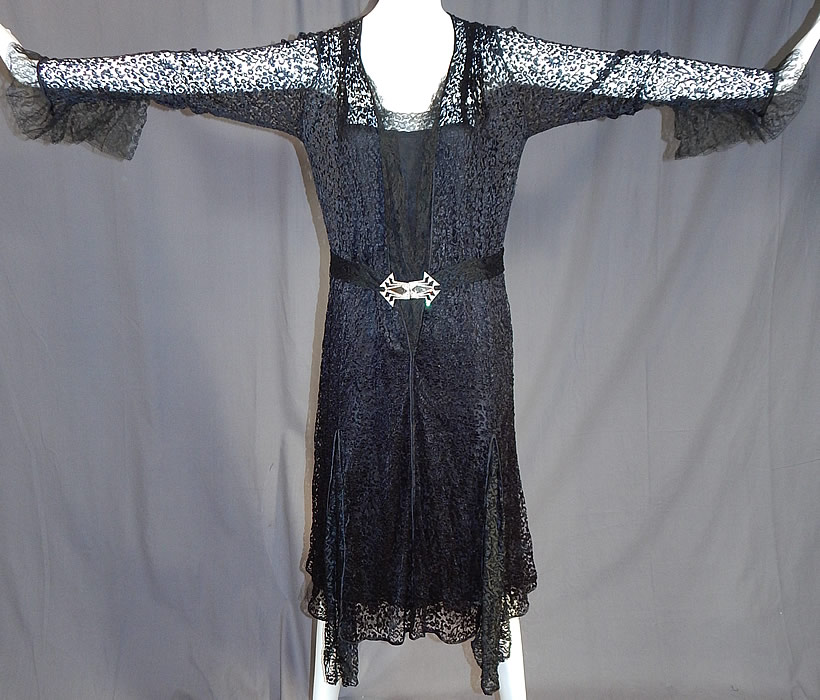 Vintage Art Deco Buckle Belted Black Silk & Chantilly Lace Flapper Dress
It is made of a sheer black silk fishnet lace fabric with a floral pattern and a fine black Chantilly lace trim edging down the top front opening and sleeve cuffs. 