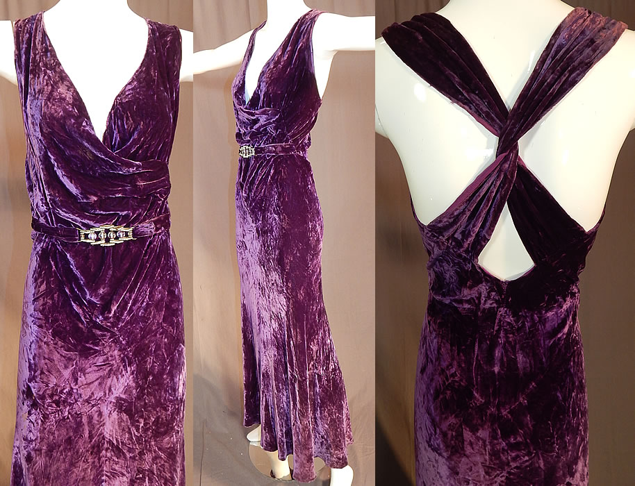 Vintage Art Deco Purple Panne Crushed Velvet Belted Bias Cut Evening Gown Dress
This gorgeous gown evening dress is a long floor length, with a sexy, sleeveless form fitting style, plunging V neckline wrap front, criss crossing twisted straps on the back, an attached belted front with movable linked rhinestone, amethyst glass beaded buckle trim, no side opening and is unlined. The dress measures 58 inches long, with 38 inch hips, a 30 inch waist and 36 inch bust.