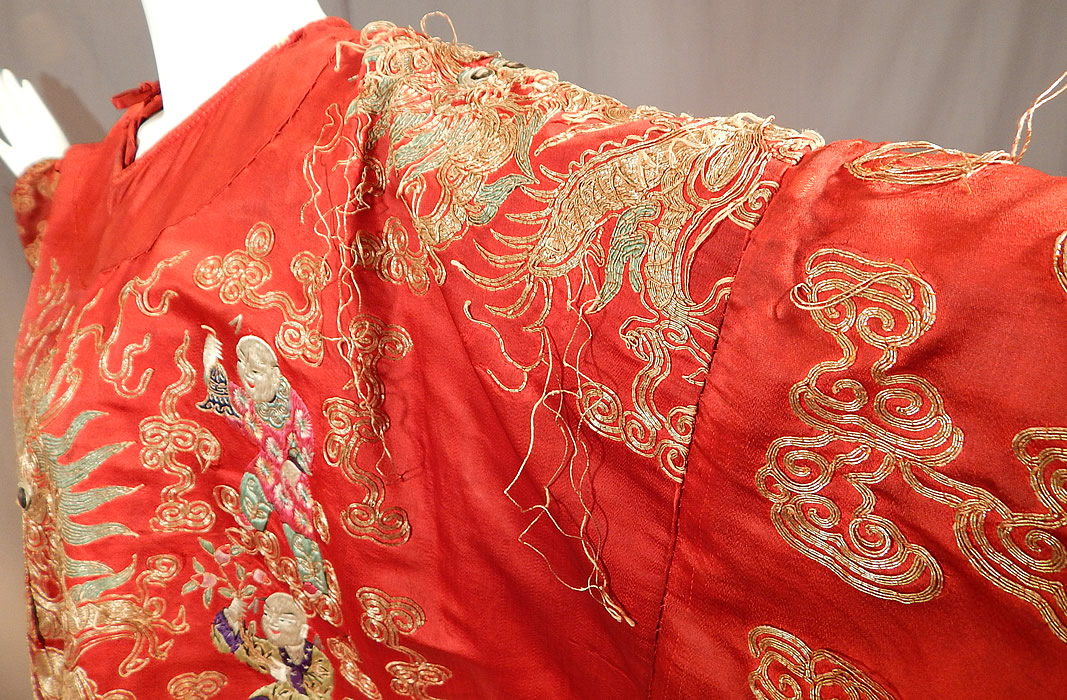 Antique Chinese Dragon Phoenix Gold Couching Embroidery Red Silk Opera Robe
It is in good as-is condition, with some faint stains, wear along the neckline, 2 missing tie strap closures and some frayed loose gold thread couching work (see close-up). This is still a wonderful piece of antique Chinese textile art!