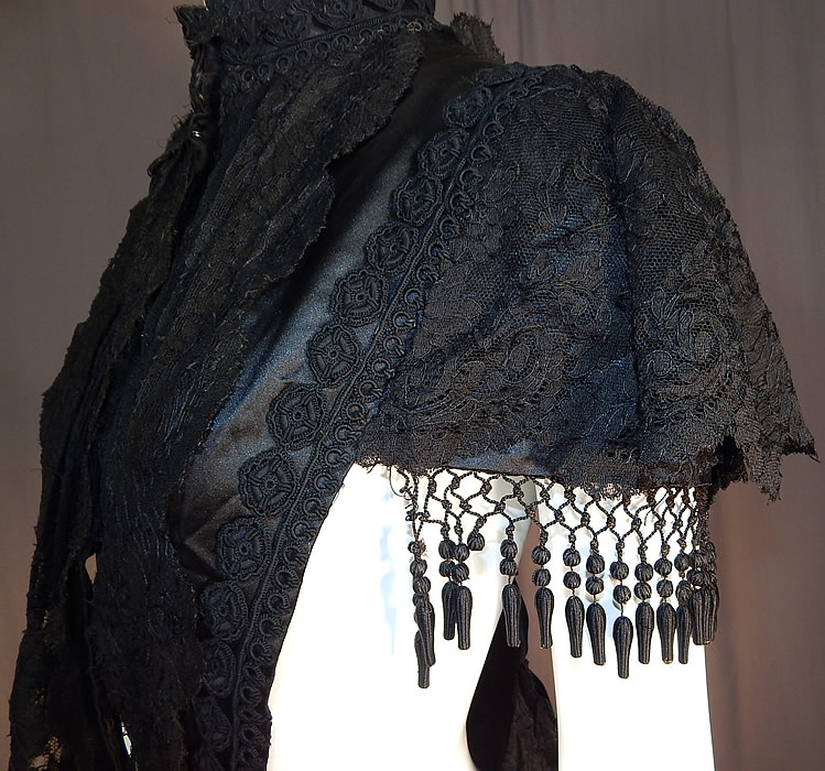 Victorian Black Silk Chantilly Lace Passementerie Mourning Mantle Pelerine Cape
It is in good as-is condition, with only a few missing silk ball fringe trim and some fraying on the inside silk lining. This is truly an amazing piece of antique Victoriana mourning wearable art!