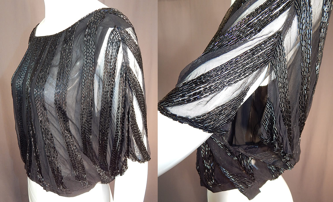 Vintage Art Deco Sheer Black Silk Beaded Batwing Sleeve Blouse Shirt Top
This beautiful beaded blouse has a loose fitting style with batwing split short sleeves, a cropped fitted waistband with side snaps, a key hole opening button back and is fully lined with a black silk chiffon camisole lining. 