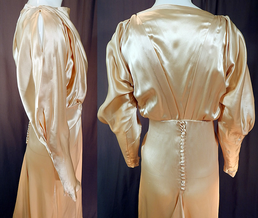 Vintage Cream Silk Charmeuse Cutout Sleeve Bias Cut Wedding Gown Train Dress
The dress measures 58 inches long in the front, 72 inches long in the back with train, a 36 inch bust, 24 inch waist and 42 inch hips. It is in good condition, with only some slight faint underarm discoloration. This is truly an amazing piece of wearable wedding bridal art!