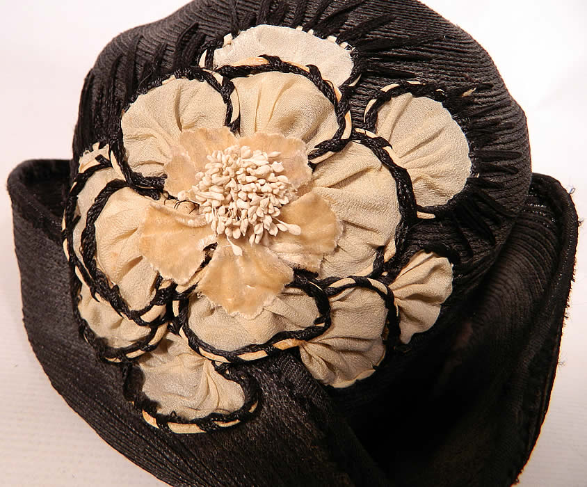 Vintage Black Straw Upturned Brim White Silk Flower Flapper Cloche Hat. It is in good condition, with only minor wear. This is truly a wonderful piece of wearable millinery art!