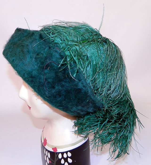 Edwardian Titanic Era Green Beaver Felt Fur Ostrich Feather Rolled Brim Hat. It is made of a dark green teal color plush beaver felt fur fabric, with dyed green ostrich feather plumes decorating the top side. 