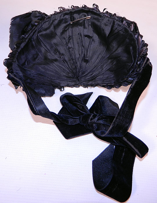 Victorian Black Straw Large Silk Bow Trim Mourning Half Bonnet Hat. It is in good condition, with some fraying of the black silk ribbon on top. This is truly a wonderful piece of wearable Victoriana mourning millinery art! 