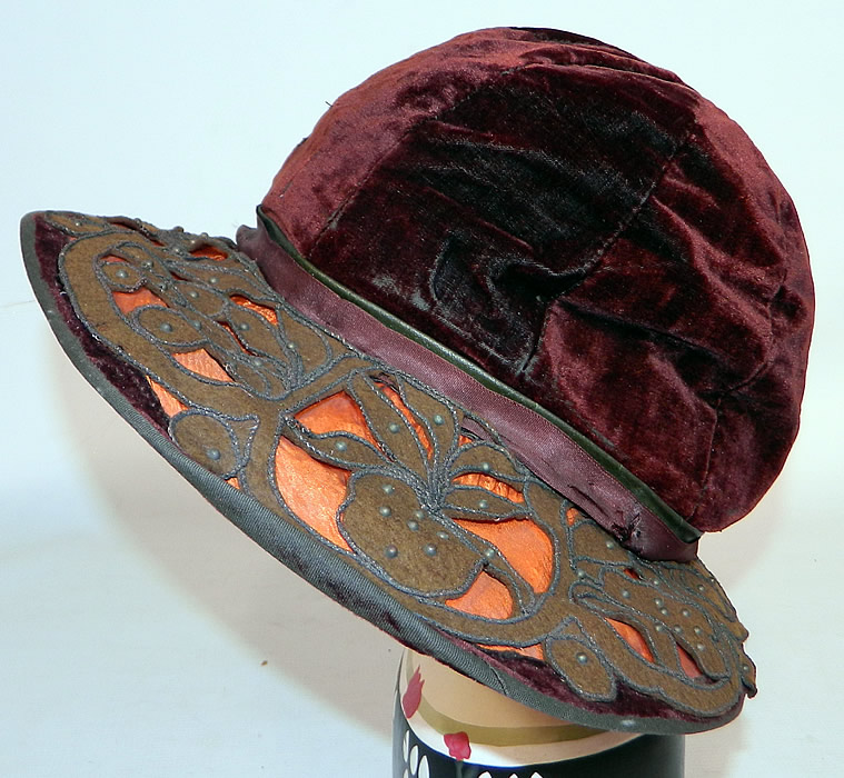 Vintage Burgundy Velvet Orange Silk Brown Cutwork Beaded Trim Wide Brim Cloche Hat
This vintage burgundy velvet orange silk brown cutwork beaded trim wide brim cloche hat dates from the 1920s.