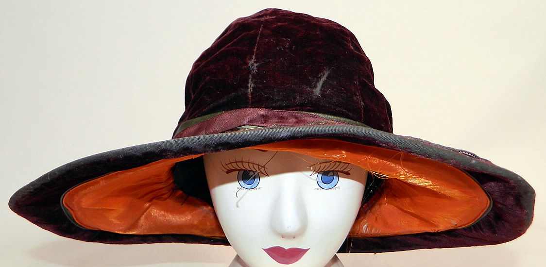 Vintage Burgundy Velvet Orange Silk Brown Cutwork Beaded Trim Wide Brim Cloche Hat
It is made of a dark red burgundy color fabric, with a orange silk lined brim covered with brown wool felt cut out fruit pears and apples trimmed with gold metallic soutache work and gold patina studded beading.