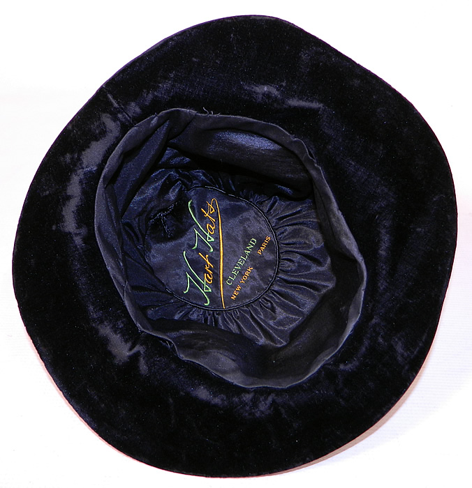 Vintage Hart Hats Black Silk Velvet Wide Brim Purple Flower Flapper Cloche Hat
The hat measures 22 inches inside crown circumference. It is in good condition, with only some minor wear to the velvet nap underneath the brim. 