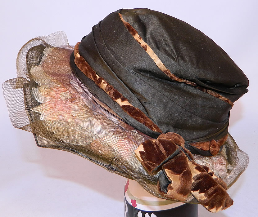 Vintage Brown Silk Voided Velvet Pink Flower Trim Wide Brim Cloche Hat
It is made of a dark chocolate brown color silk fabric, with a golden brown burnout voided velvet fabric bow trim edging and pale pink silk flowers encased under the sheer brown woven horse hair brim.