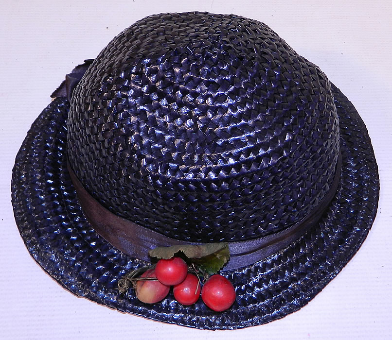 Vintage Navy Blue Woven Straw Red Cherry Silk Ribbon Bow Trim Childs Cloche Hat
The hat is made of a navy blue woven straw, with matching blue silk ribbon hat band bow and red cherry trim. 