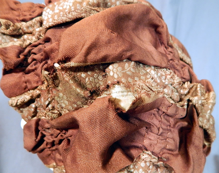 Victorian Brown Silk Ruched Ribbon Steel Cut Button Trim Carriage Bonnet Travel Cap Hat
The bonnet measures 26 inches in circumference. It is in good as-is condition, with some small frayed splits in the silk fabric side and on the silk ties (see close-up). This is truly a wonderful piece of Victoriana millinery art.