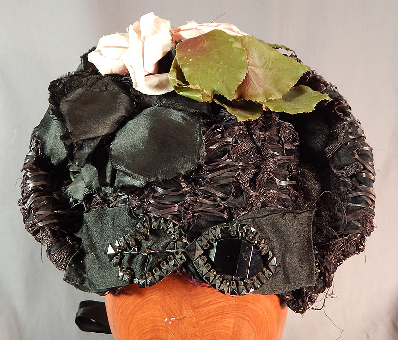 Victorian Woven Black Straw Pink Roses Jet Beaded Buckle Trim Bonnet Hat
The bonnet measures 8 by 7 inches, with a 5 inch wide inside crown. It is in good condition. This is truly a wonderful piece of wearable antique Victoriana millinery art!