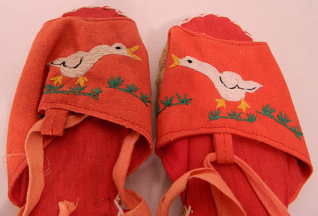 Vintage Red Linen Geese Ankle Tie Rope Sole Childrens Beach Sandal Shoes. They are made of a red linen fabric, with white embroidered geese duck designs on the front vamps.