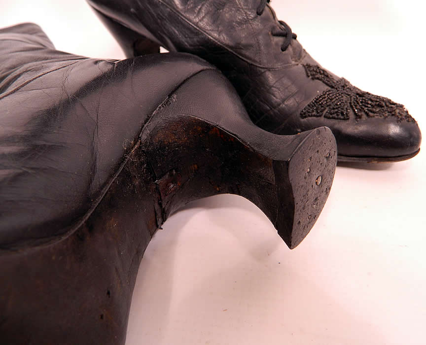 Victorian Antique Black Leather Jet Beaded High Top Lace-up Boots heel close up. They have been gently worn, with some scuffs, missing beading off the front toes and a repaired mended crack underneath the arch of one heel 