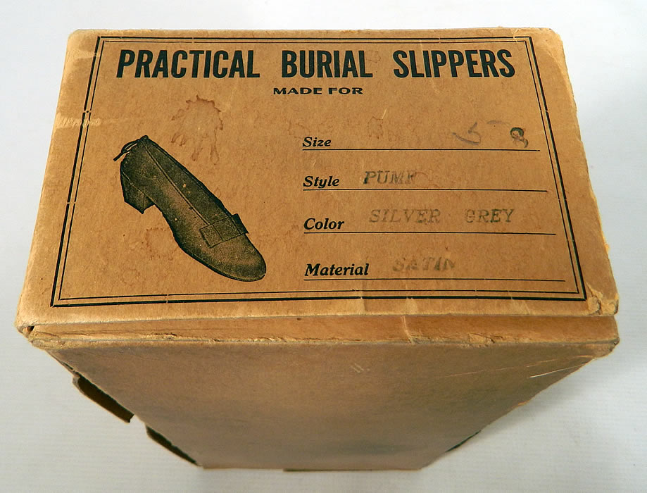 Vintage Practical Burial Slippers Silver Grey Satin Funeral Shoes Pumps. They come in the original box stamped "Practical Burial Slippers Made For" with a stamped size 8. 