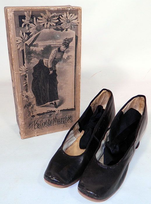 Victorian Kelly & Murphy Black Leather Ribbon Tie Shoes & Box. he shoes measure 10 inches long, 2 1/2 inches wide, with 1 1/2 inch high heels and are marked as a size 6. They come with the original box from "Kelly and Murphy" which has beautiful black & white graphics print designs of a woman in 1880s dress and animals. 