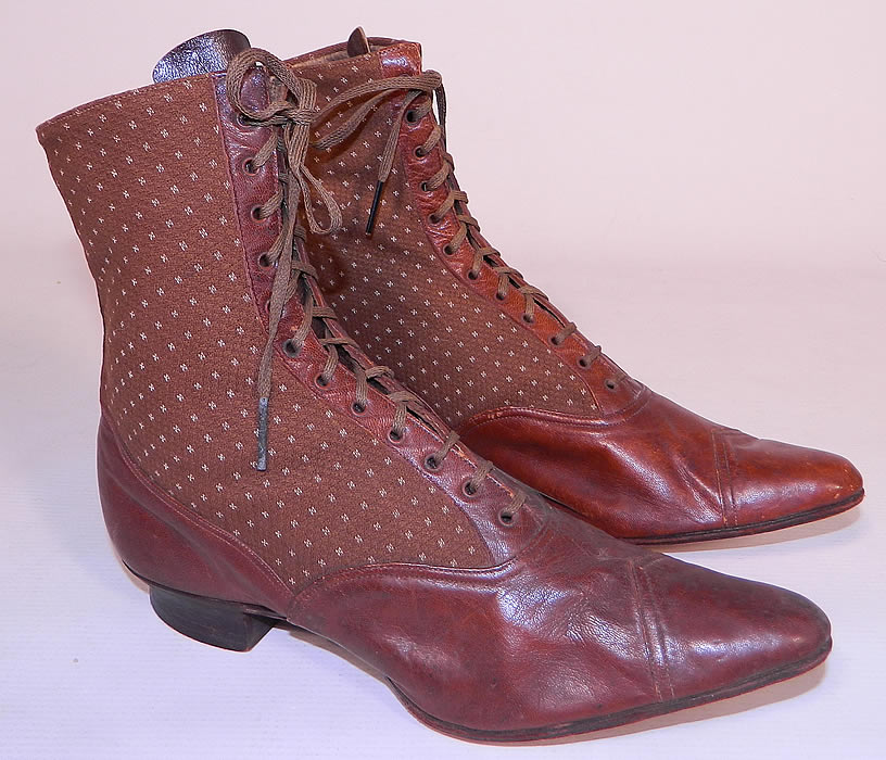 Victorian Brown Brocade Wool & Leather Two Tone High Top Lace-up Boots. The boots have the original brown shoe laces, pointed toes with a decorative scallop trim design, leather trim strip on the front & back and stacked wooden low cube heels. 