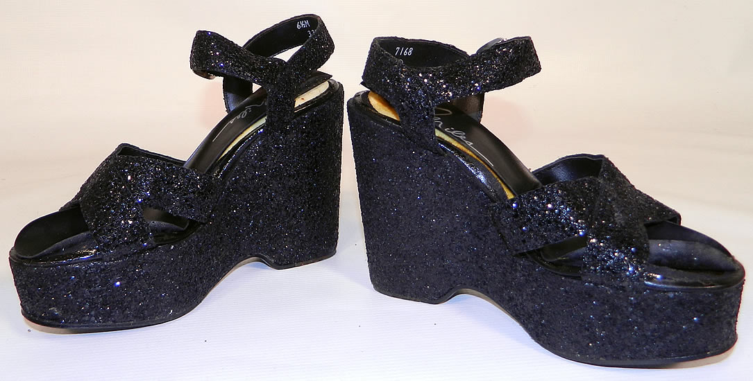 Vintage Miles Black Glitter Disco Platform Shoes & Purse Set. The shoes measure 9 1/2 inches long, 2 1/2 inches wide, with a 5 inch high heel. They are in good condition and have been gently worn, with only some minor wear and lifting of along the insoles. 