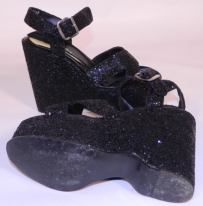 Vintage Miles Black Glitter Disco Platform Shoes & Purse Set. The shoes measure 9 1/2 inches long, 2 1/2 inches wide, with a 5 inch high heel. They are in good condition and have been gently worn, with only some minor wear and lifting of along the insoles. 