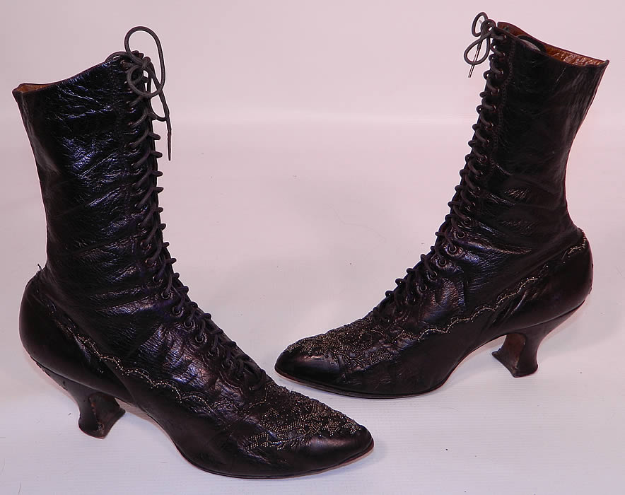 Victorian Aubergine Leather Steel Cut Beaded Patriotic Stars High Top Lace-up Boots. This pair of antique Victorian era aubergine leather steel cut beaded patriotic stars high top lace-up boots date from 1890. They are made of an iridescent dark purplish brown aubergine eggplant color leather, with steel cut beading done in a patriotic star pattern design on the front toes and decorative beading going around the sides.