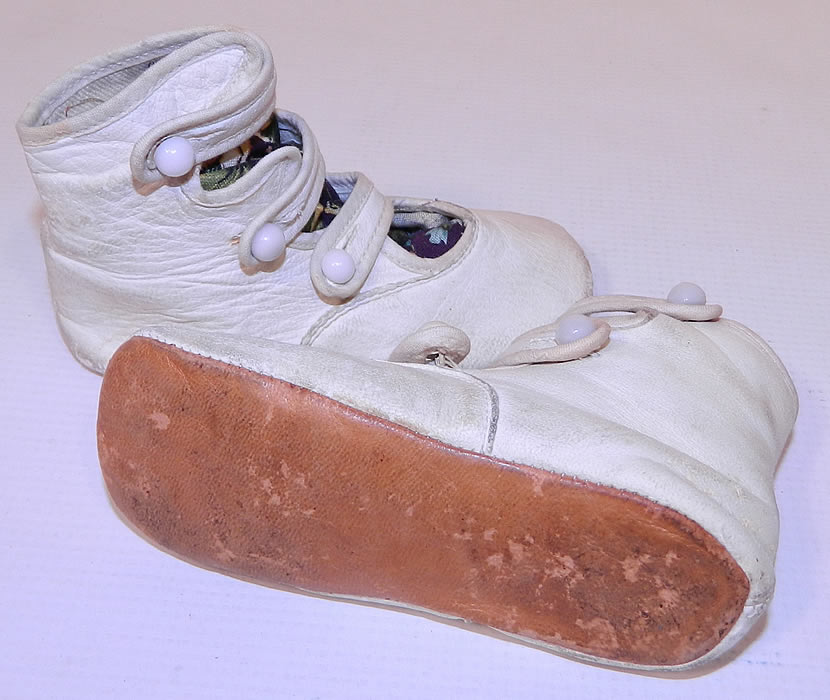 Victorian White Kid Leather High Button Strap Baby Boots Infant Childrens Shoes. These charming children's high top baby boots infant shoes have rounded toes and leather bottom soles. The shoes measure 3 inches tall, 5 inches long and 2 inches wide.