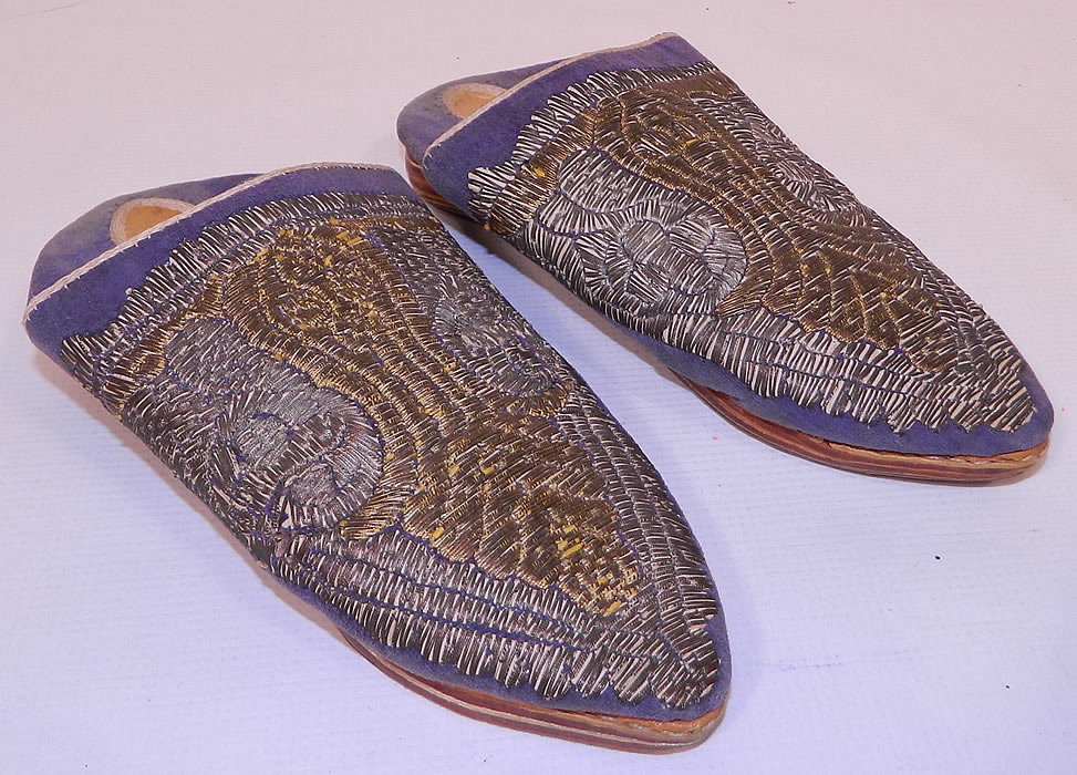 Vintage Moroccan Ladies Mules Cherbil Metal Embroidery Velvet Slipper Shoes. This pair of vintage Morocco ladies mules cherbil metal embroidery velvet slipper shoes date from the early 1900s. They are made of purple velvet, with hand embroidered gold and silver gilded wire thread embroidery couching needlework.