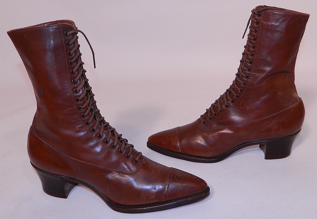 Unworn Victorian Brown Leather High Top Lace-up Boots Poehlman Shoe Co. They are made of a supple brown leather, with decorative punch work designs on the toes. 