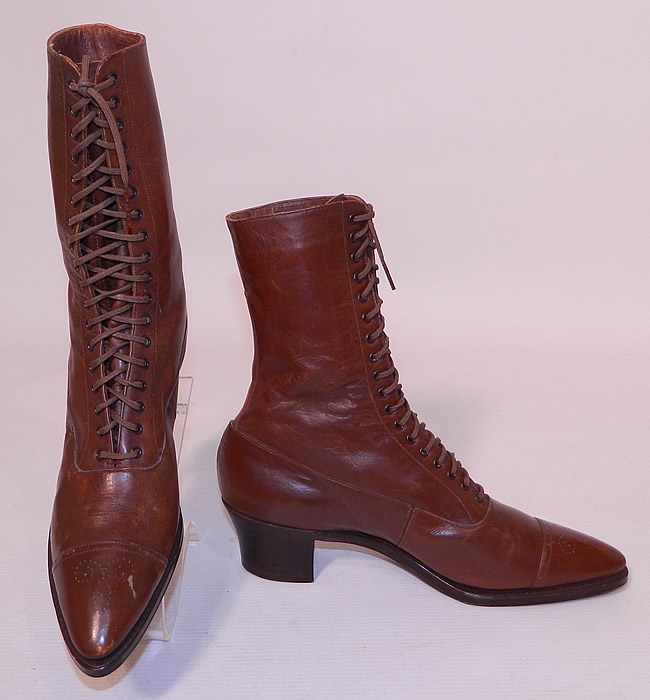 Unworn Victorian Brown Leather High Top Lace-up Boots Poehlman Shoe Co. The boots have pointed toes, the original brown shoe string laces for closure and stacked  wooden cube heels.