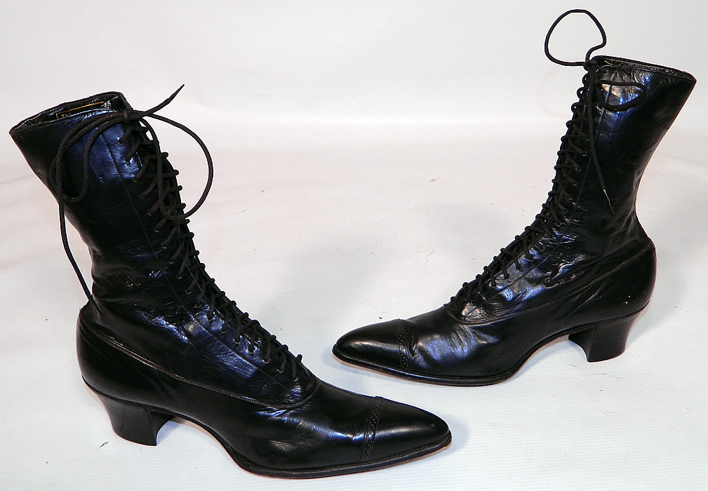 Vintage Poehlman Shoe Co Unworn Victorian Black Leather High Top Lace-up Boots. This pair of vintage Poehlman Shoe Co unworn Victorian era antique black leather high top lace-up boots dates from 1900. They are made of a supple black leather, with decorative punch work designs across the toes. 