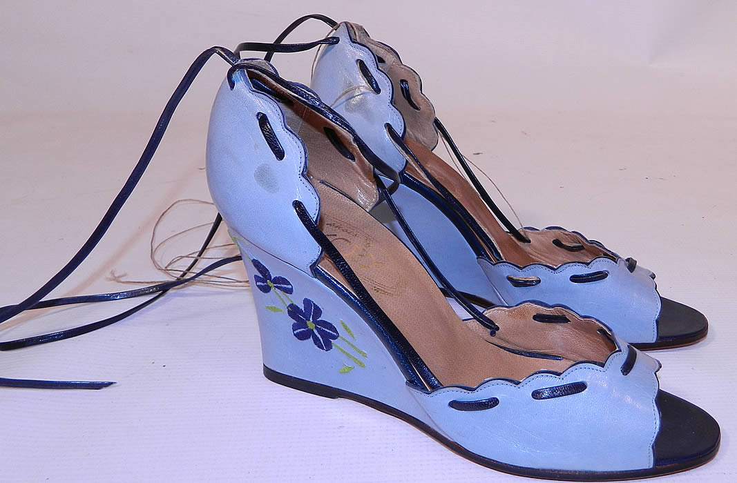 Vintage Shoes by Ivory Blue Leather Floral Embroidery Ankle Strap Wedge Heel. This pair of vintage Shoes by Ivory blue leather floral embroidery ankle strap wedge heel date from the 1970s. They are made of a two tone blue leather, with embroidered flowers on the side heels.