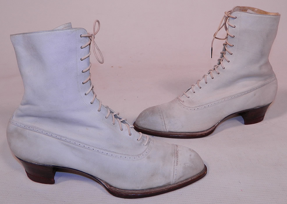 Vintage Nihleen NY Label Victorian White Suede Leather High Top Lace-up Boots
This pair of vintage Nihleen NY label Victorian era antique white suede leather high top lace-up boots dates from 1900. They are made of a white suede leather, with decorative punch work designs.