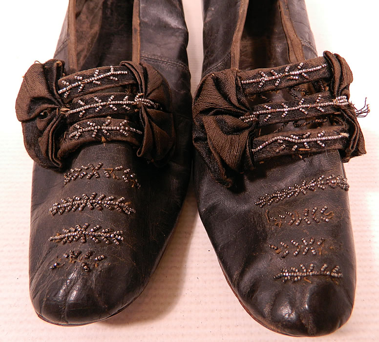 Victorian Black Leather Silk Bow Steel Cut Beaded Louis XV Heel Shoes
They are in good condition and have been gently worn, with some minor wear, slight fraying on the silk bow, a few missing and rusted beads. These are truly a beautiful quality made antique Victoriana shoe which would make for a wonderful display piece!