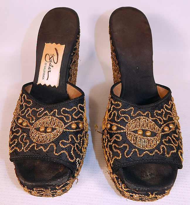 Vintage Ryder of California Black Gold Studded Soutache Wedge Heel Platform Shoes
The shoes measure 9 1/2 inches long, 2 3/4 inches wide, with a 1 inch front platform lift, 4 1/2 inch high heels and are approximately a size 7.