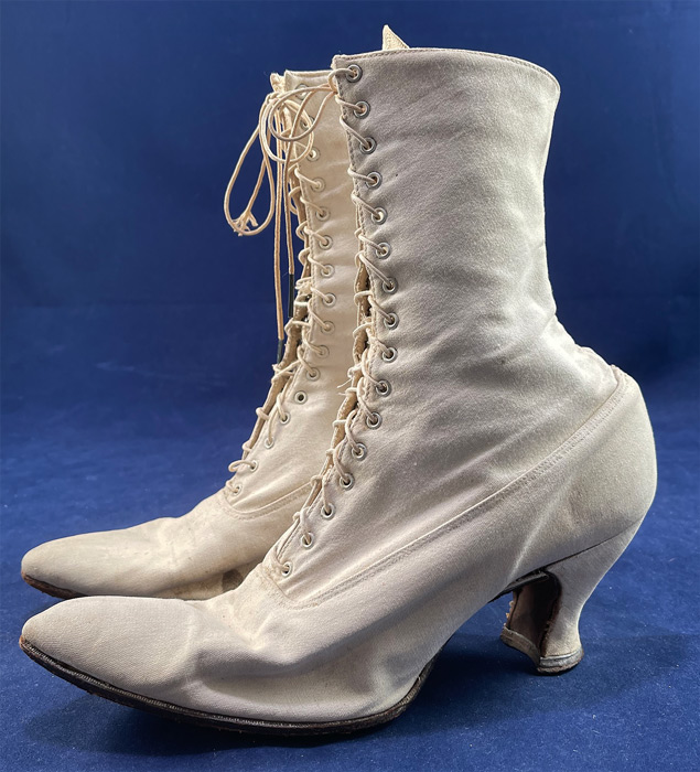 Victorian Antique White Canvas High Top Lace-up Boots French Spool Heels
These beautiful boots have slightly upturned pointed toes, the original shoe string laces which are a bit frayed and canvas covered French spool heels. The boots measure 10 inches tall, 10 1/2 inches long, 3 inches wide, with a 3 inch high heel. 