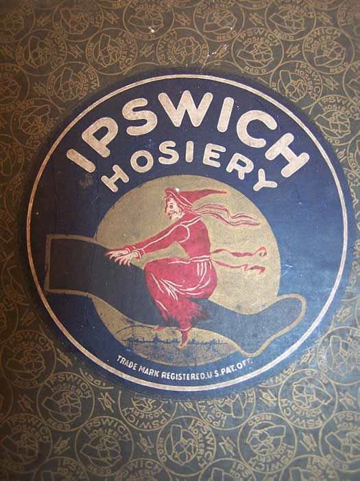 Antique Ipswich Hosiery Box & Black Silk Stockings side view.