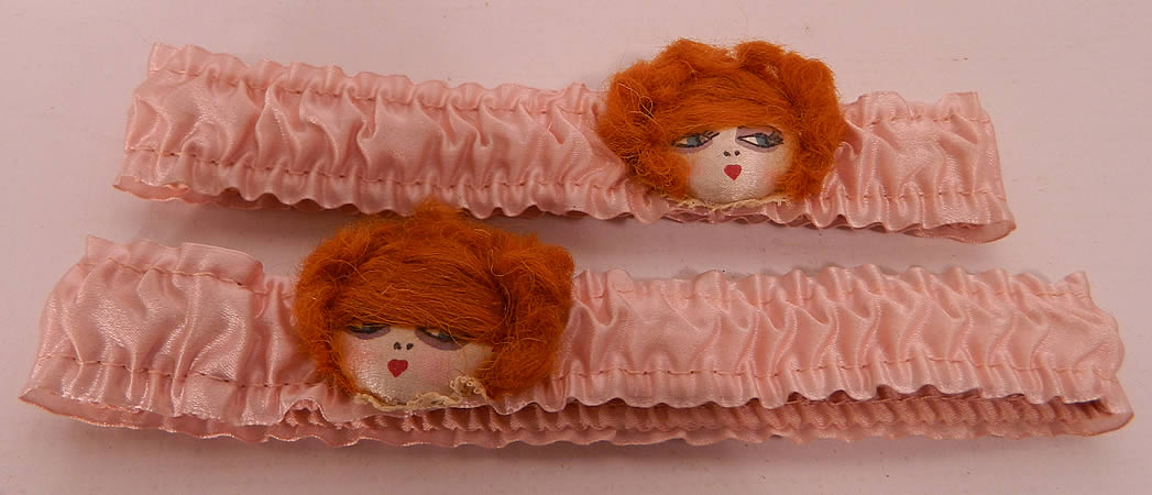 Unworn Vintage Pink Silk Hand Painted Red Head Flapper Girl Garters. They are made of pink silk, with silk covered hand painted faces, heart shape lips, sultry eyes, red hair and a white lace trim ruffle collar underneath.