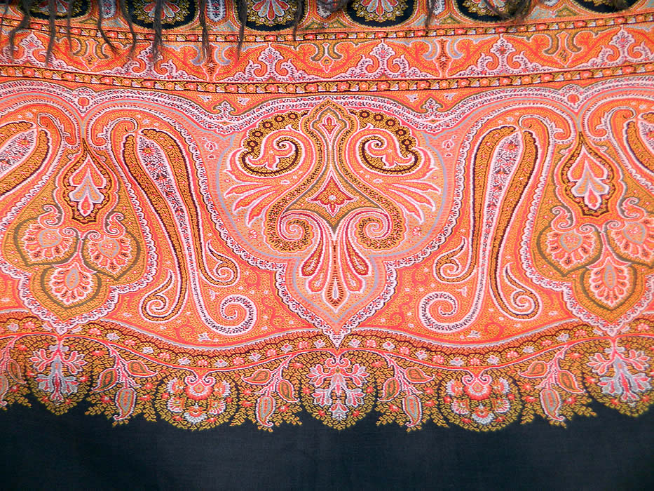 Victorian Antique Jacquard Loom Wool Large Black Square Center Paisley Shawl. This stunning shawl has wonderful workmanship and detail, with a large black wool square center, decorative black fringe border trim along the top and bottom, with a green selvage side edging.