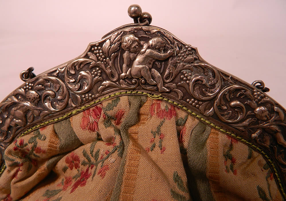 Antique Silver Plate Repousse Cherub Cupid Frame French Silk Brocade Fabric Purse. There is a silver ball clasp closure on the top and chain link strap.