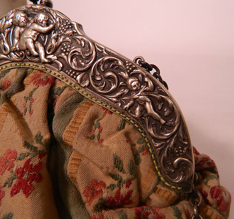 Antique Silver Plate Repousse Cherub Cupid Frame French Silk Brocade Fabric Purse. The purse measures 9 inches tall and 8 1/2 inches wide.