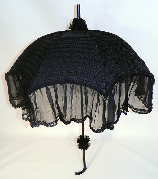 Edwardian Black Silk Zigzag Stitched Carved Ebony Handle Parasol. There is a carved black ebony wood handle and finial top with black silk scrunchie ruffle trim accents.