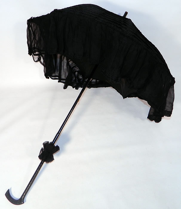 Edwardian Black Silk Zigzag Stitched Carved Ebony Handle Parasol. This pretty parasol umbrella has a pagoda dome shape with metal frame and is fully lined inside. The parasol measures 38 inches long and 80 inches in circumference when opened. 