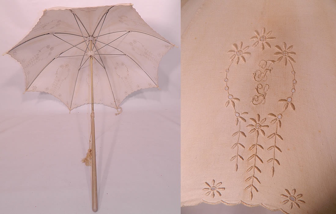 Edwardian Eyelet Embroidered White Linen Wood Handle Summer Parasol.  The parasol measures 40 inches long and 104 inches in circumference when opened. 