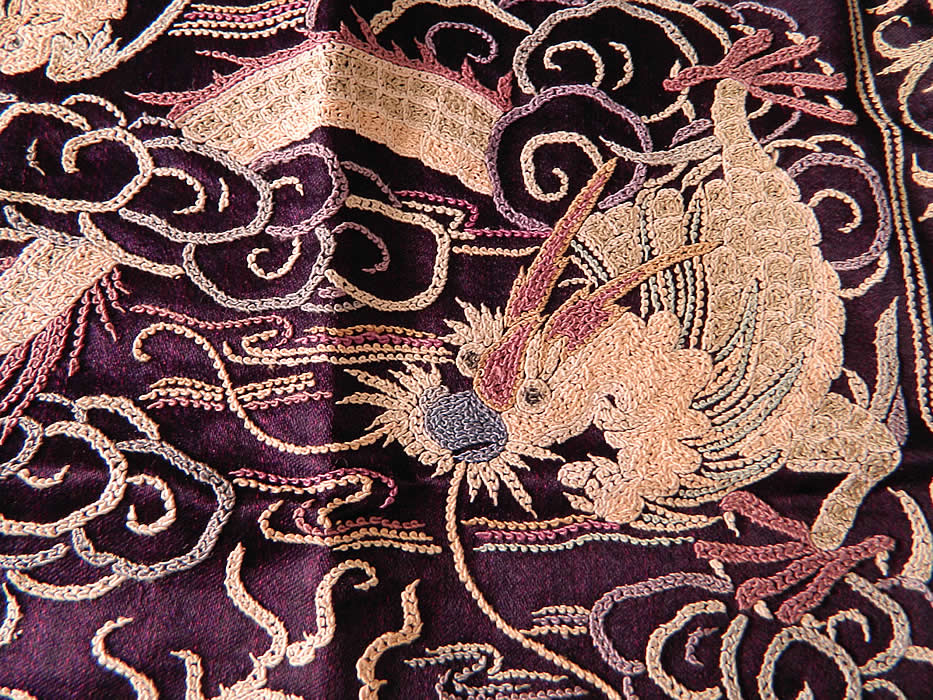 Antique Chinese Silk Embroidered Forbidden Stitch Dragon Bat Badge Purse. Two matching embroidered square badges have been sewn together creating a purse with a rounded corner bottom, scalloped edge thread loop top for inserting a drawstring closure carrying strap, white silk tassel fringe trim on the sides and is fully lined in a bright blue silk lining. 