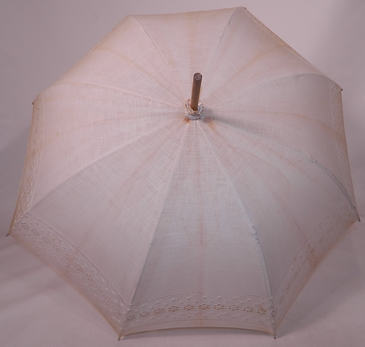 Edwardian White Linen Eyelet Burl Wood Handle Summer Pagoda Parasol. There is a natural burl wood handle and wooden finial top with gathered scrunchie fabric trim. 