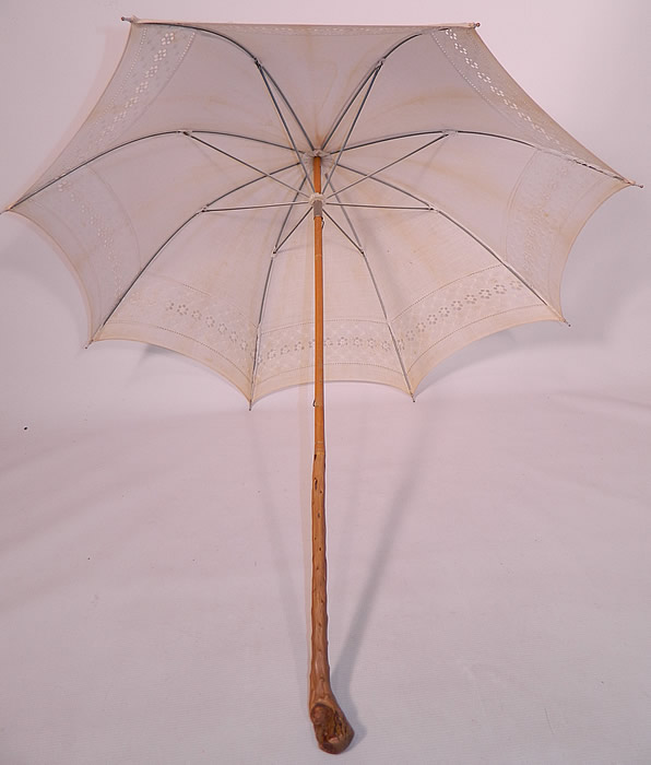 Edwardian White Linen Eyelet Burl Wood Handle Summer Pagoda Parasol. This pretty parasol summer umbrella has a pagoda dome shape, with metal frame inside. The parasol measures 36 inches long and 96 inches in circumference when opened.