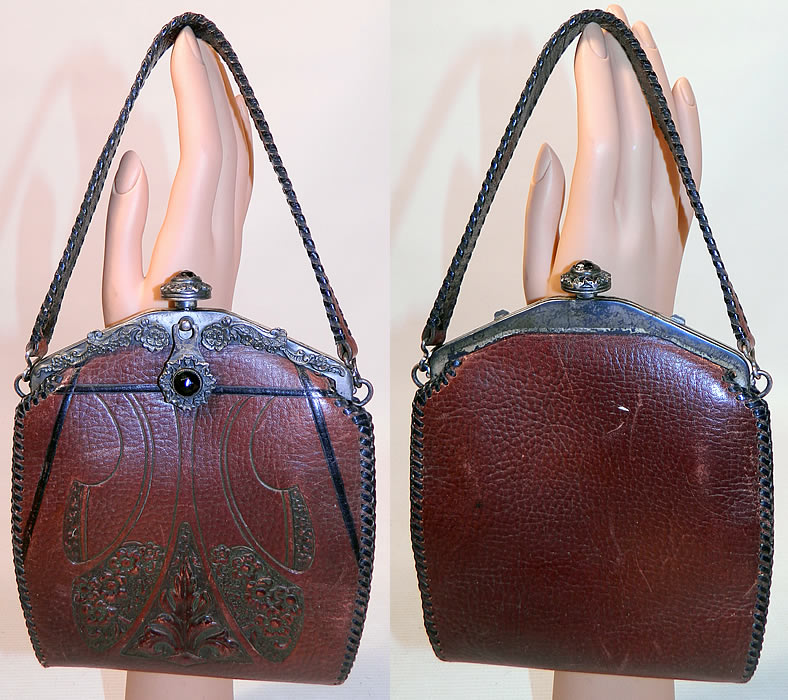 Vintage Arts & Crafts Tooled Leather Whip Stitch Jeweled Silver Frame Handbag  Purse. This vintage Arts & Crafts tooled leather whip stitch jeweled silver frame handbag purse dates from 1917. It is made of hand tooled leather, with an Arts & Crafts floral design pattern on the front and black trim highlights.