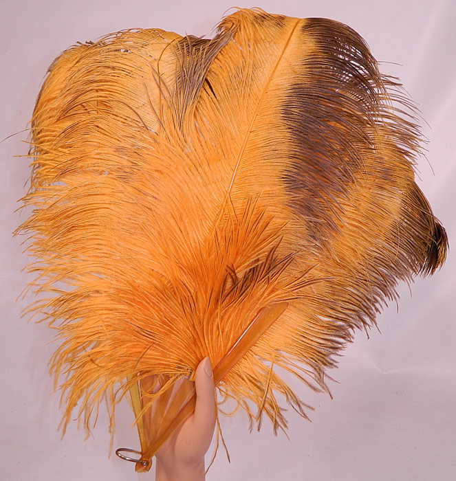 Vintage Golden Butterscotch Yellow Brown Tip Ostrich Feather Flapper Fan. This vintage golden butterscotch yellow brown tip ostrich feather flapper fan dates from the 1920s.