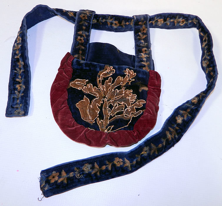 Victorian Antique Printed Velvet Soutache Embroidered Belted Pouch Purse. This Victorian era antique printed velvet soutache embroidered belted pouch purse dates from 1870. It is made of a printed blue velvet fabric, with a decorative floral design pattern outlined on the front with raised soutache embroidery work and red velvet ruched gathering trim edging. 